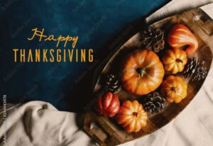 Happy Thanksgiving text on autumn pumpkin flat lay background.